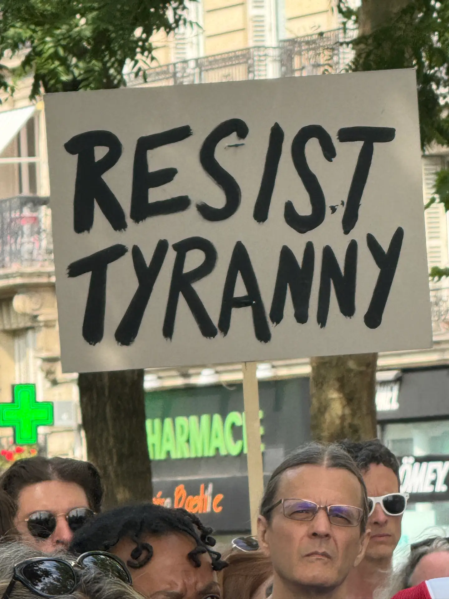 protest sign says resist tyranny